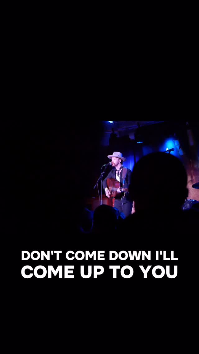 Trappers Pass playing live on a blue-lit stage