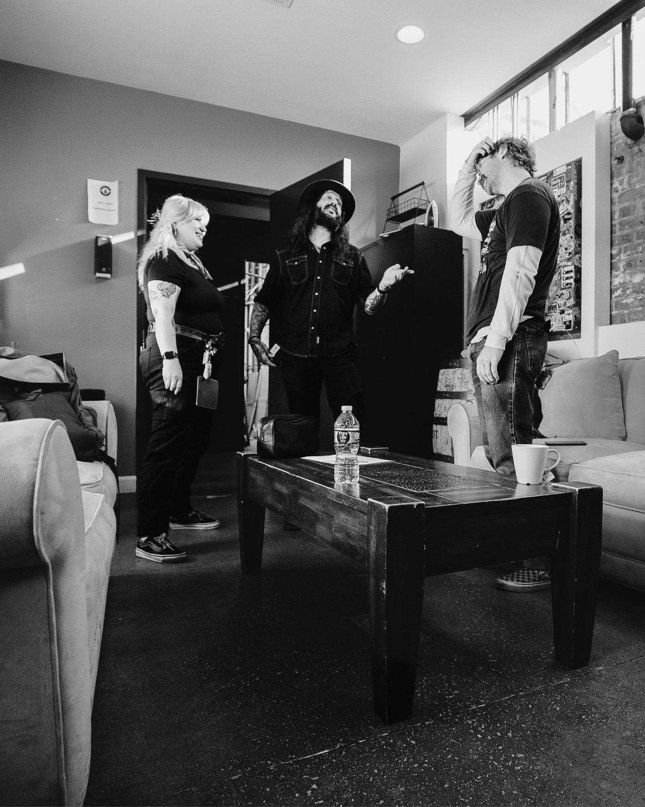 Black and white photo of Shawn James and the tour crew in the green room